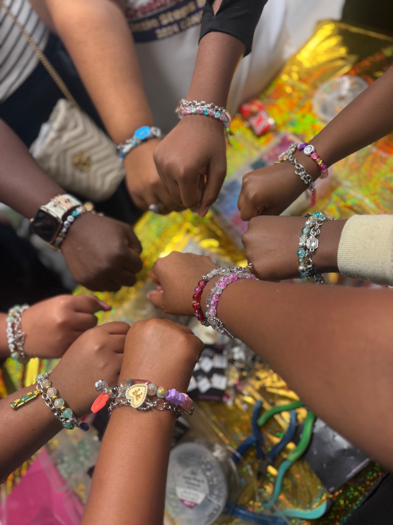 Guests showing their handmade bracelets at a stillHER birthday Bracelet Bar