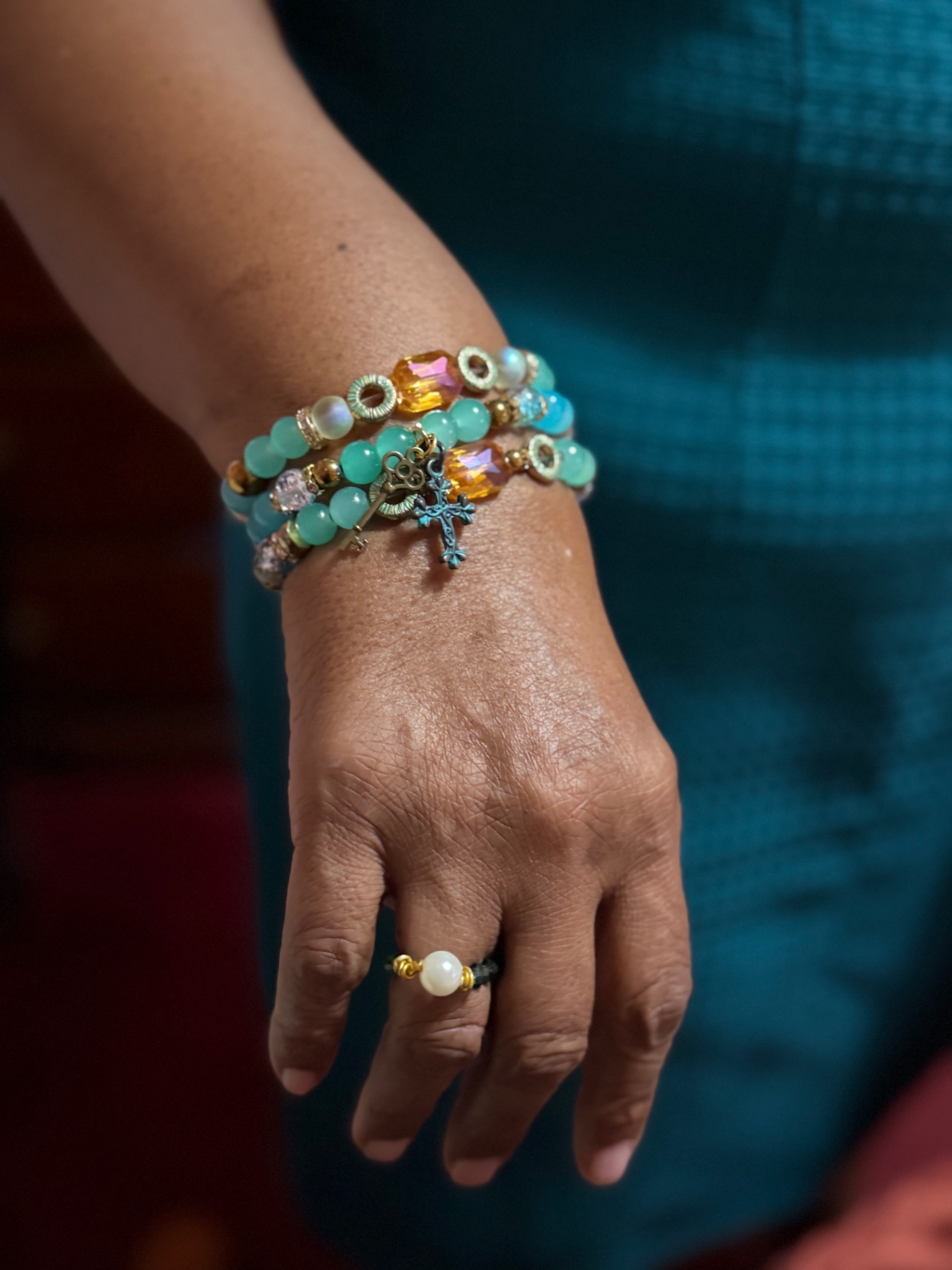 Woman wearing a three-bracelet stillHER stack